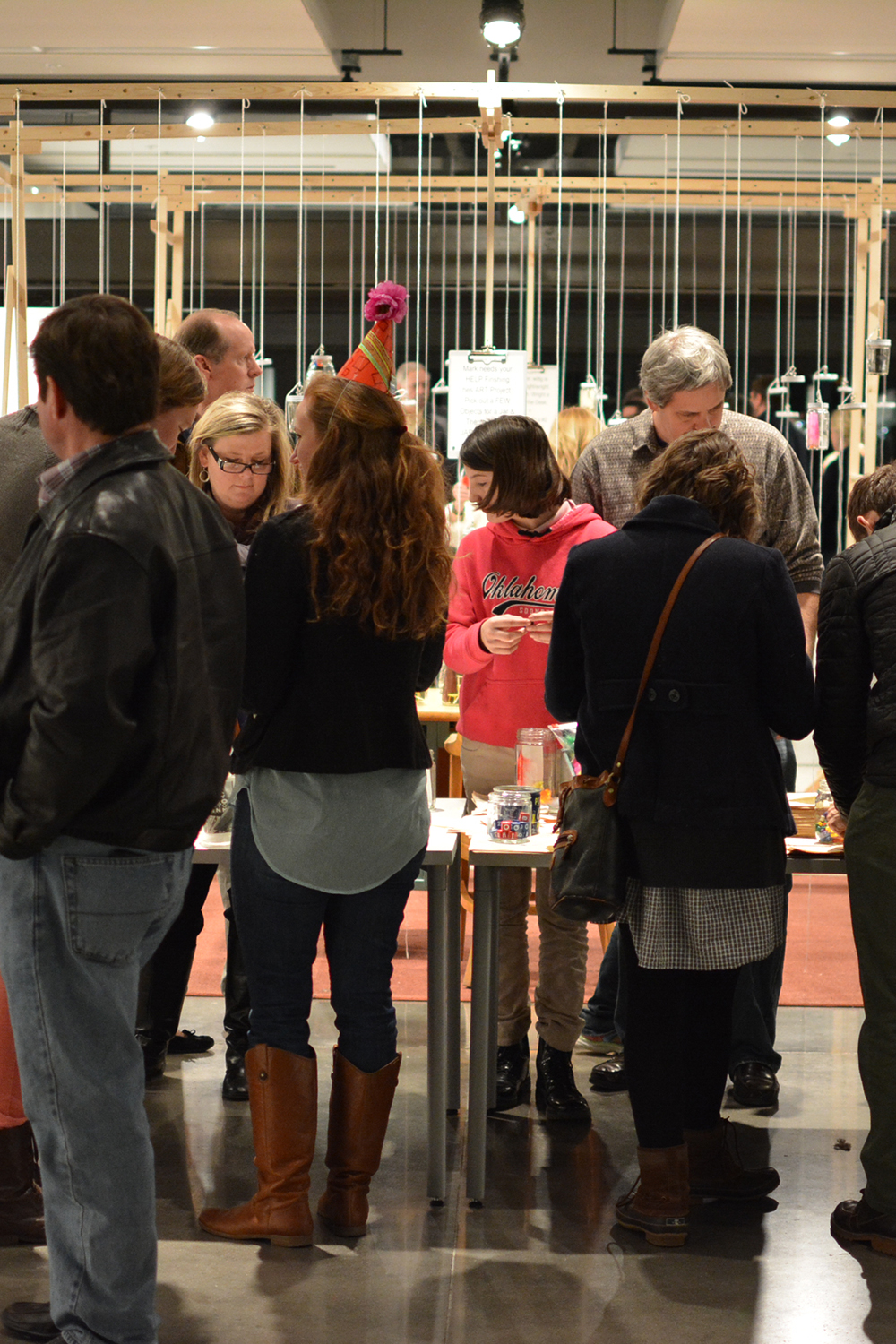Visitors filling the jars with objects during the opening reception.